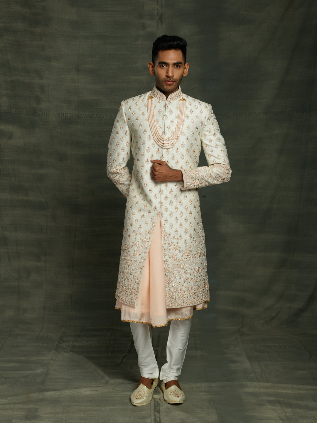 Off-white sherwani with floral motif.