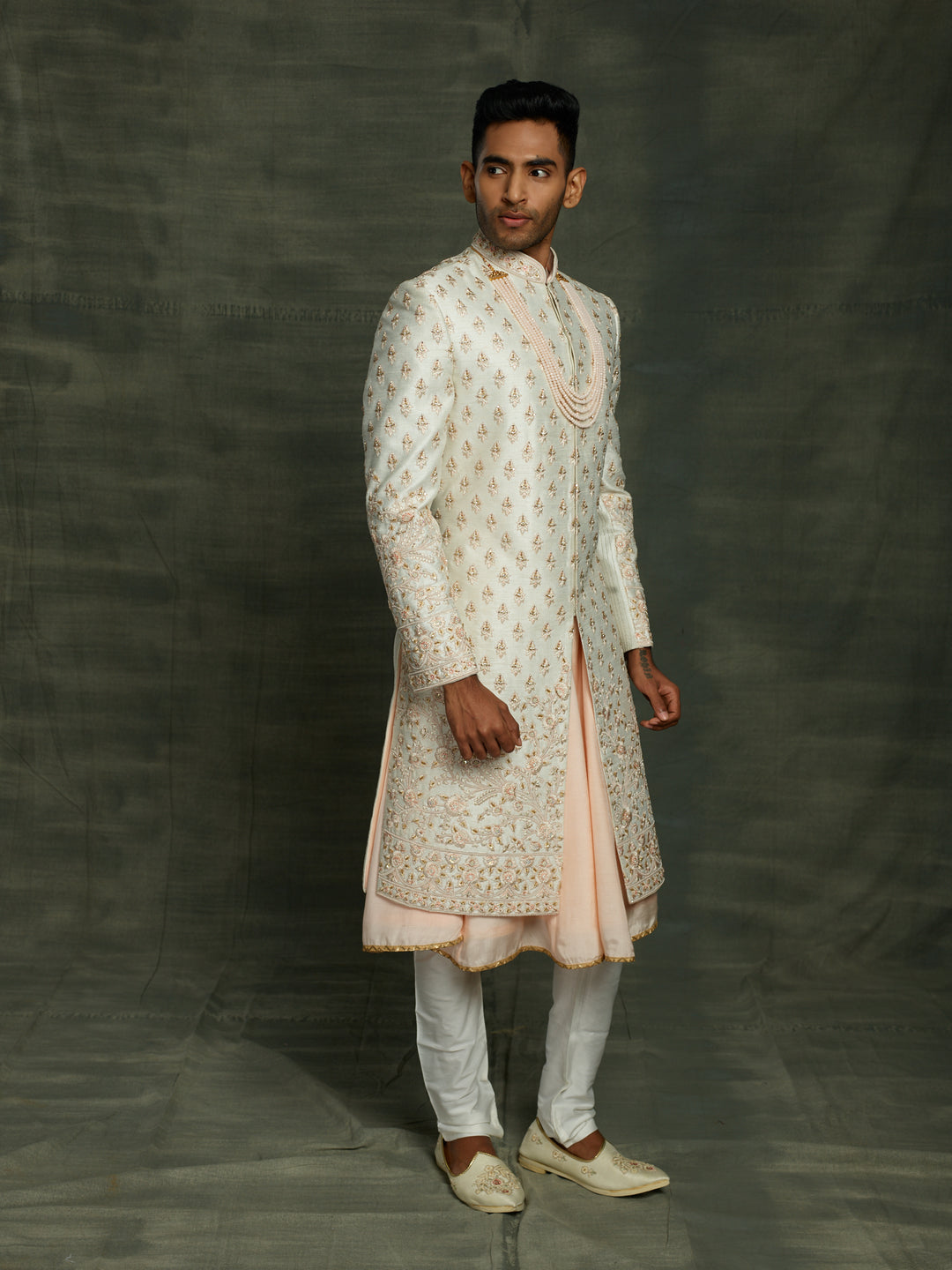 Off-white sherwani with floral motif.