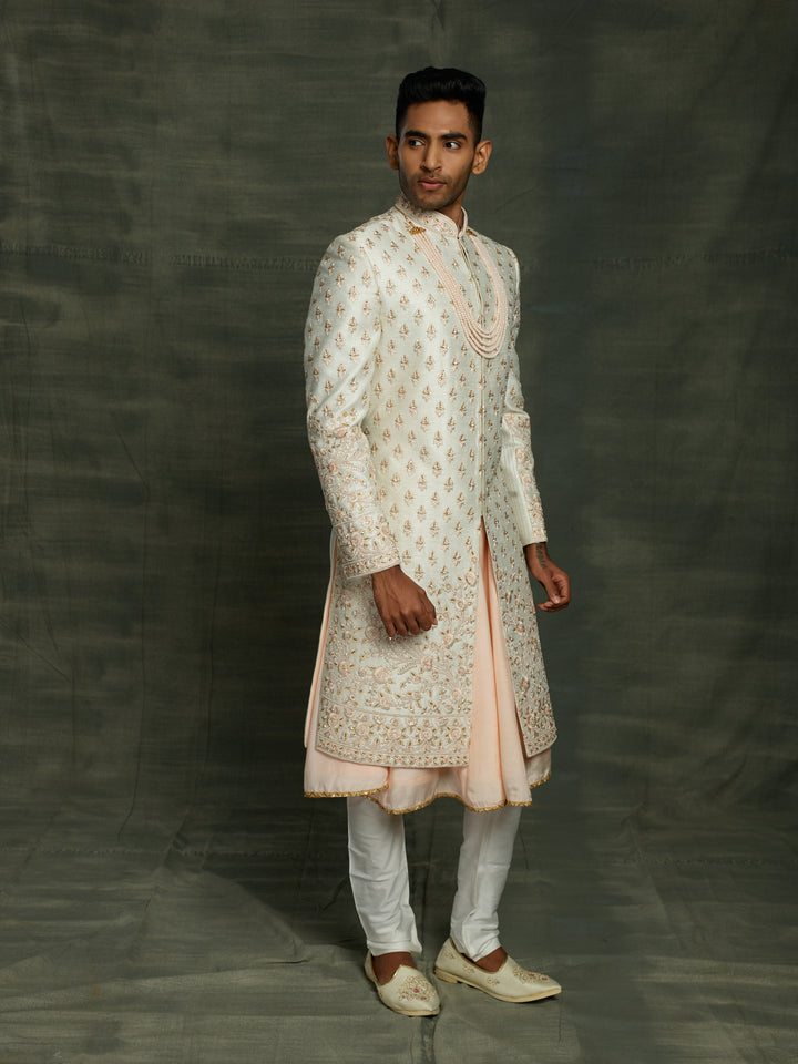 Off-white sherwani with floral motif.