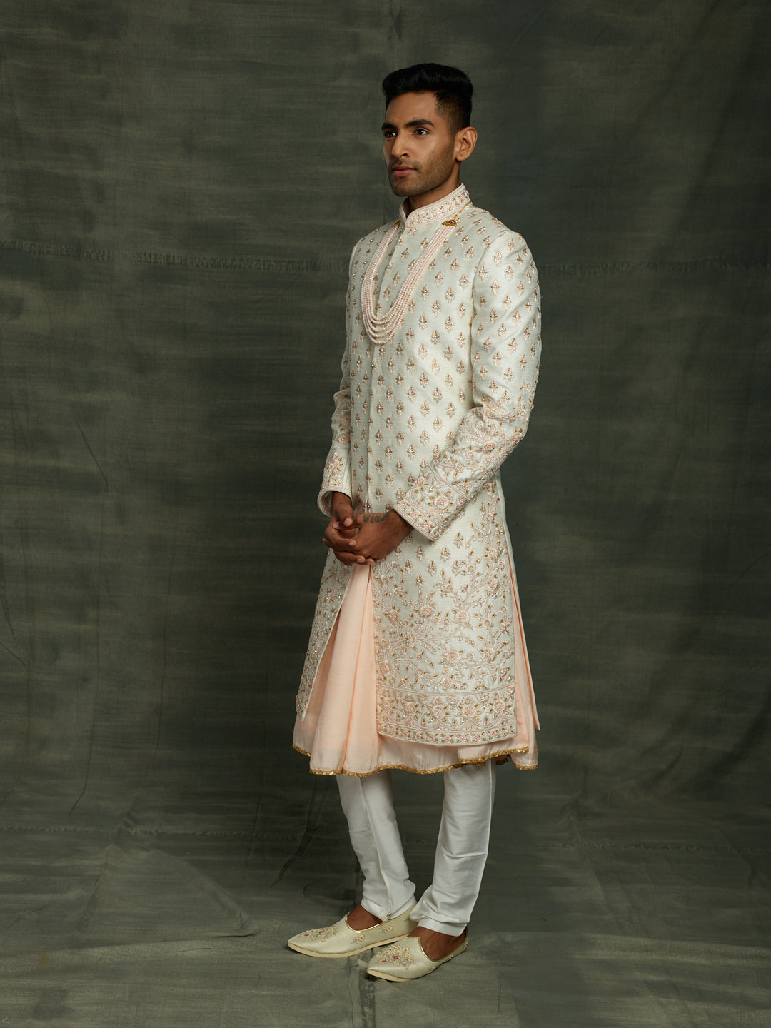 Off-white sherwani with floral motif.