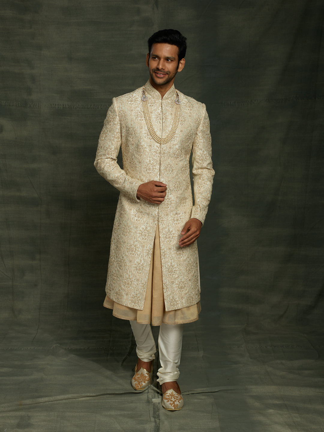 Cream sherwani with self embroidery.