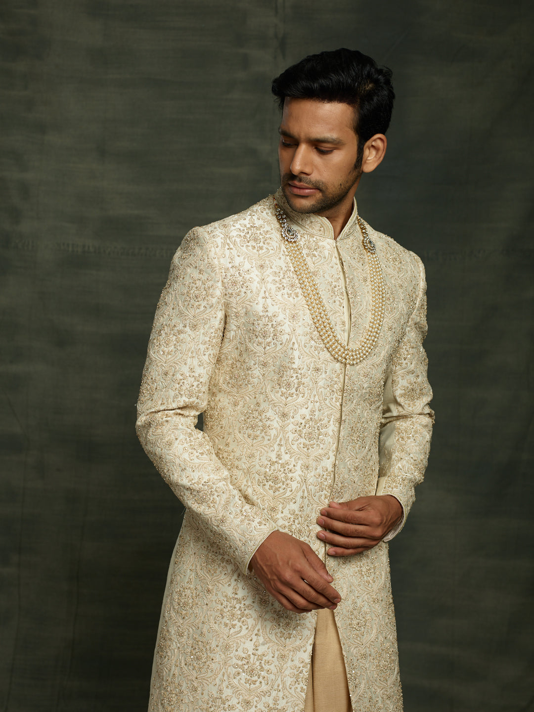Cream sherwani with self embroidery.
