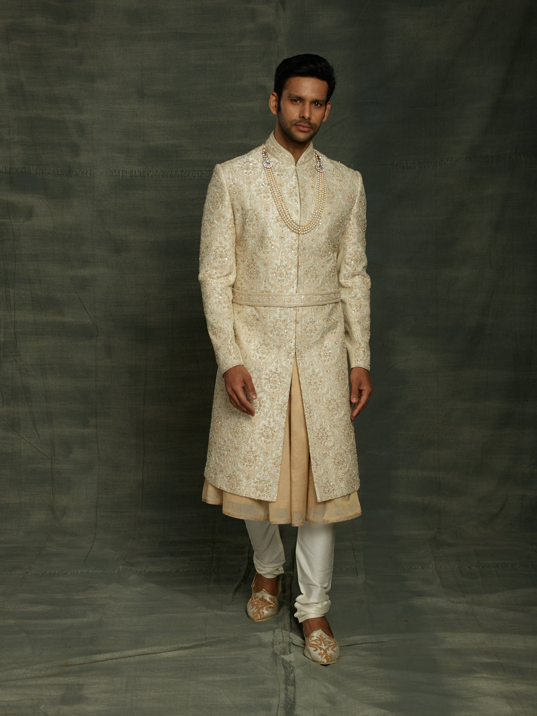 Cream sherwani with self embroidery.