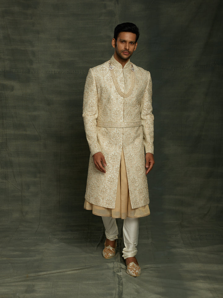Cream sherwani with self embroidery.