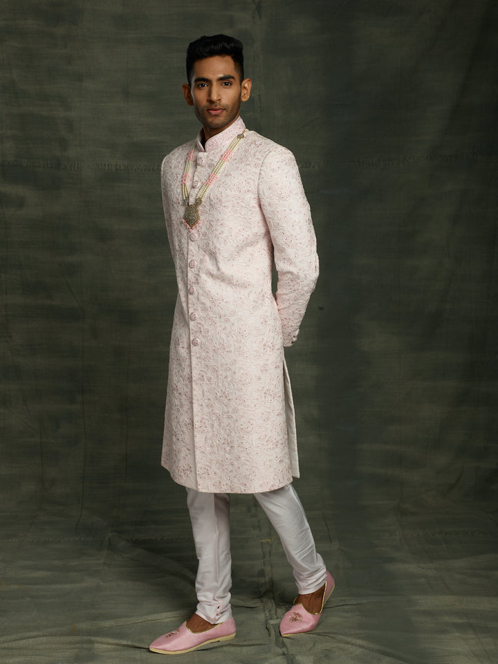Simple net based sherwani in baby pink color.