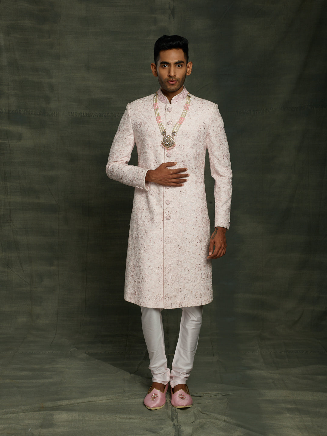 Simple net based sherwani in baby pink color.