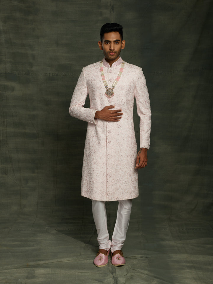 Simple net based sherwani in baby pink color.