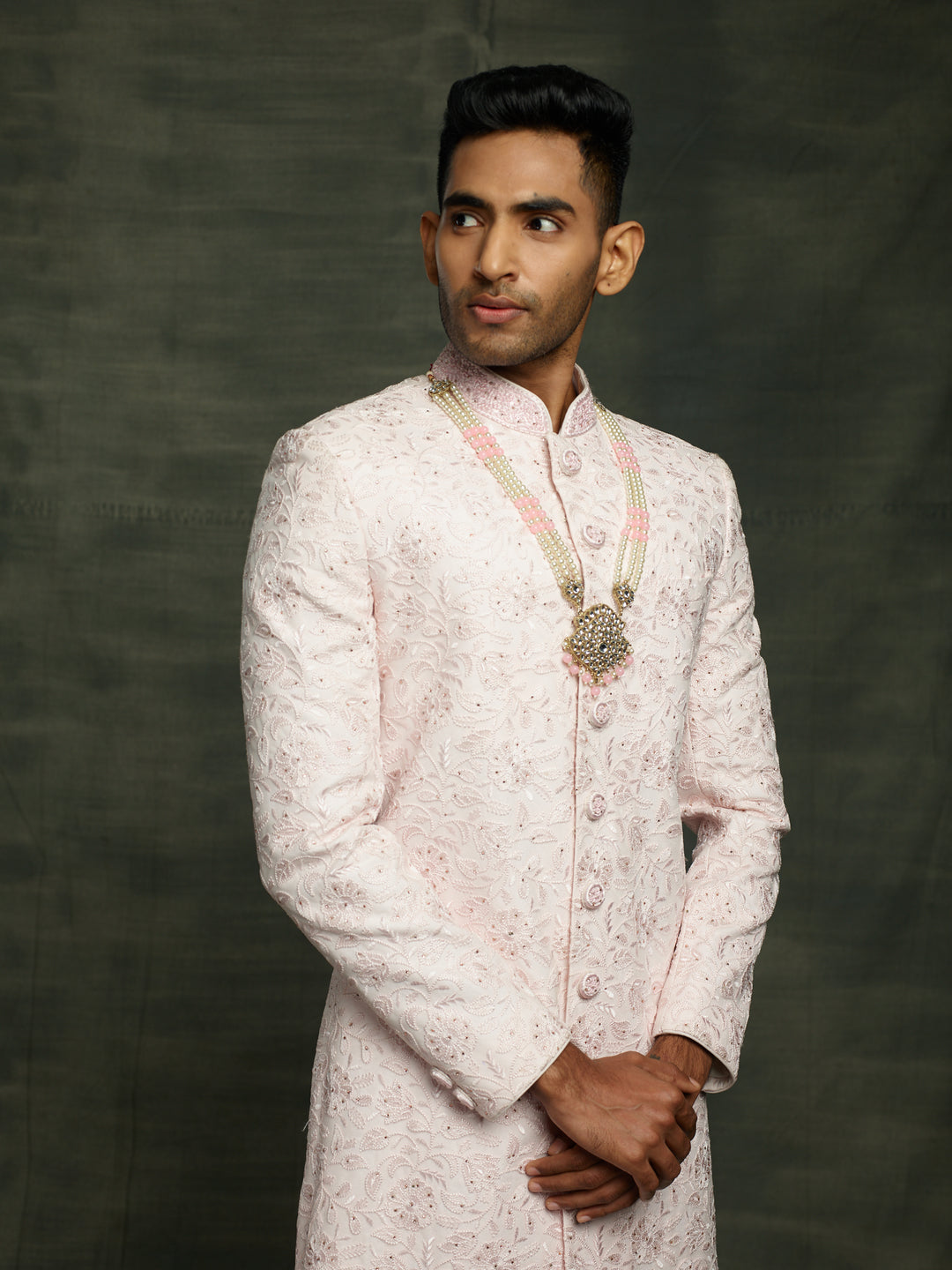 Simple net based sherwani in baby pink color.