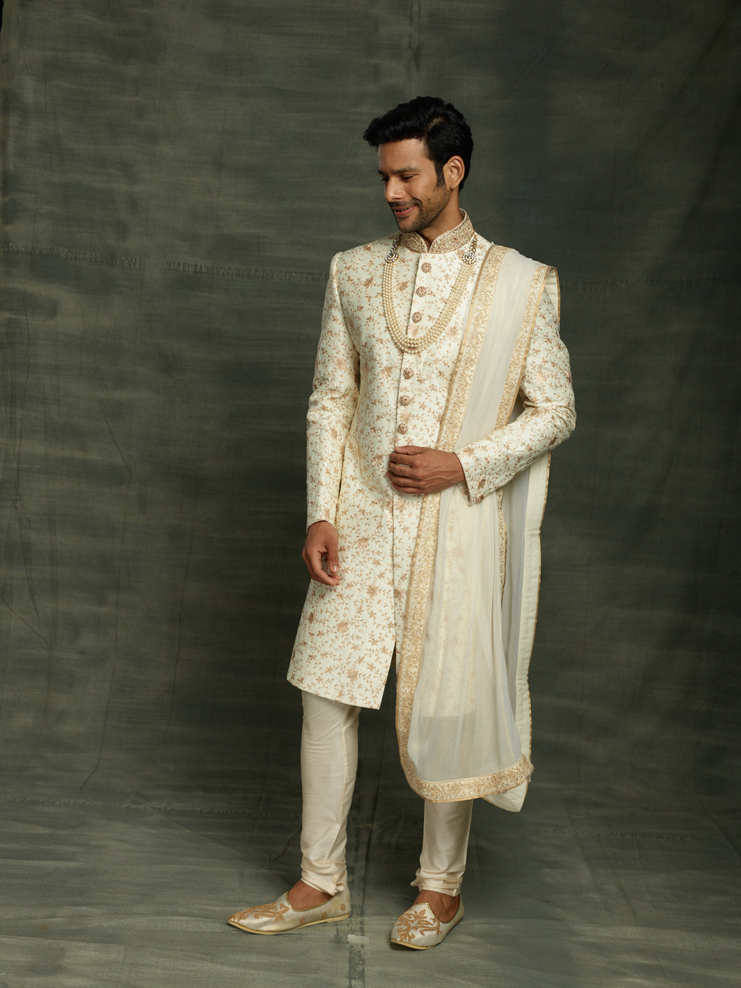off-white sherwani with dupatta.