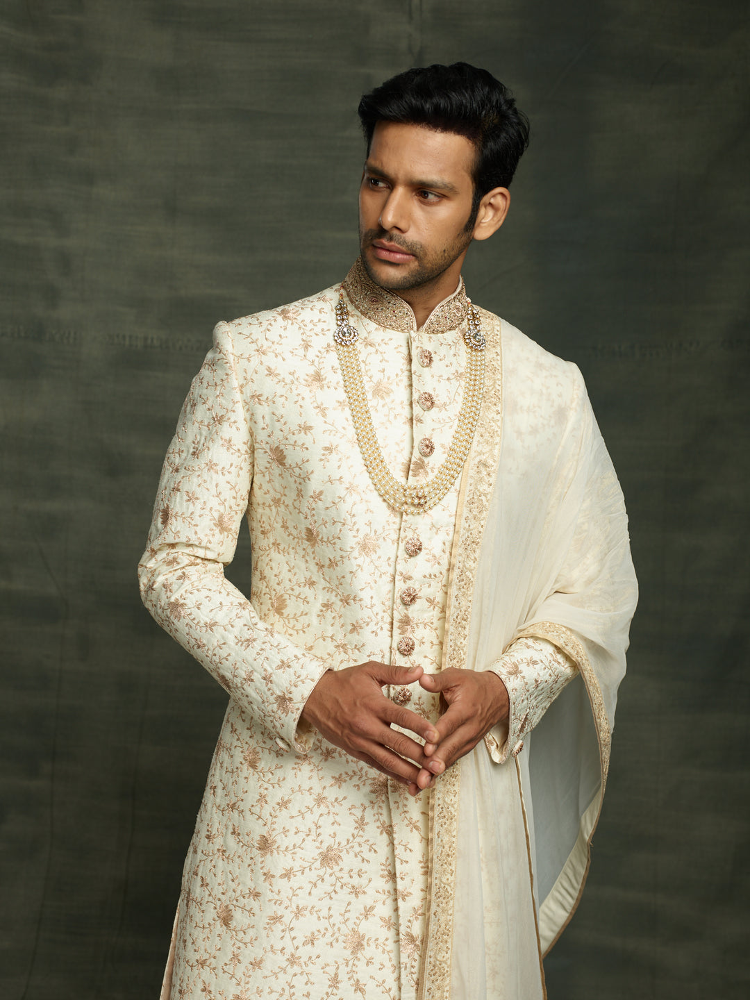 off-white sherwani with dupatta.