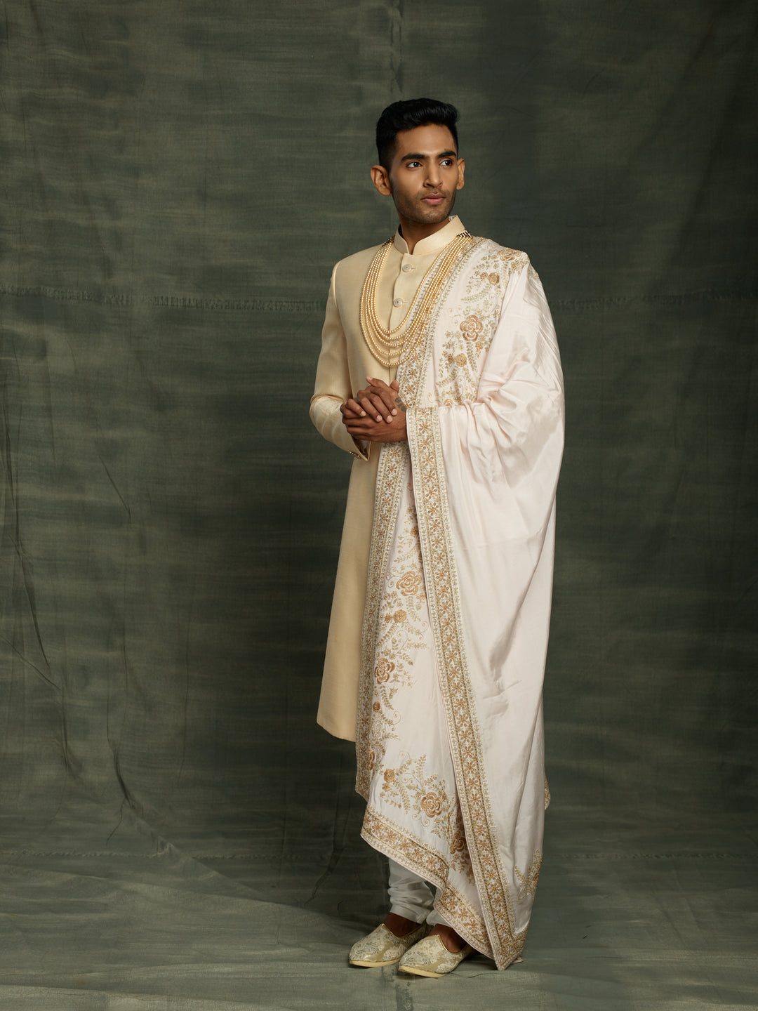 Gold sherwani with off-white dupatta.