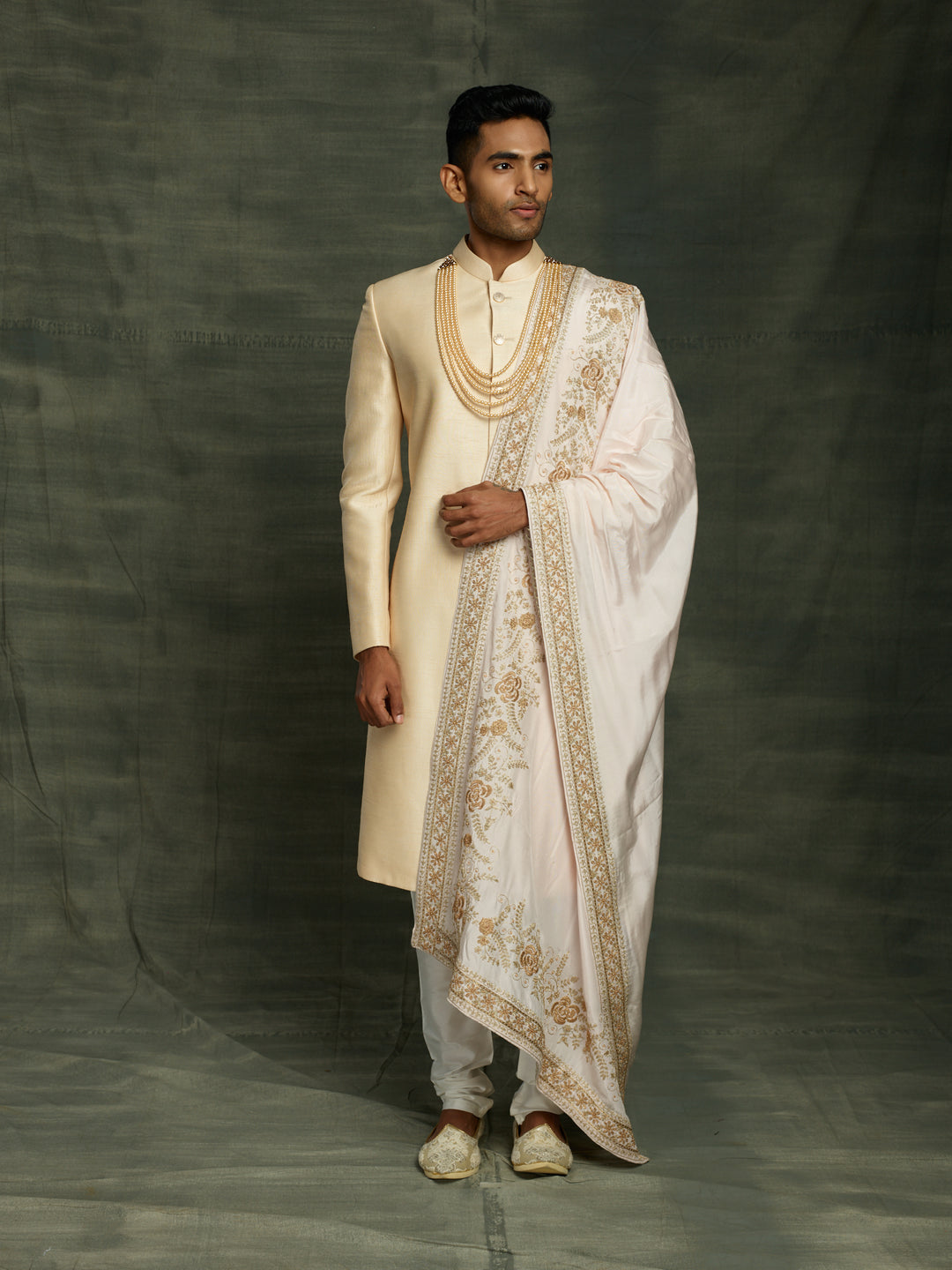 Gold sherwani with off-white dupatta.