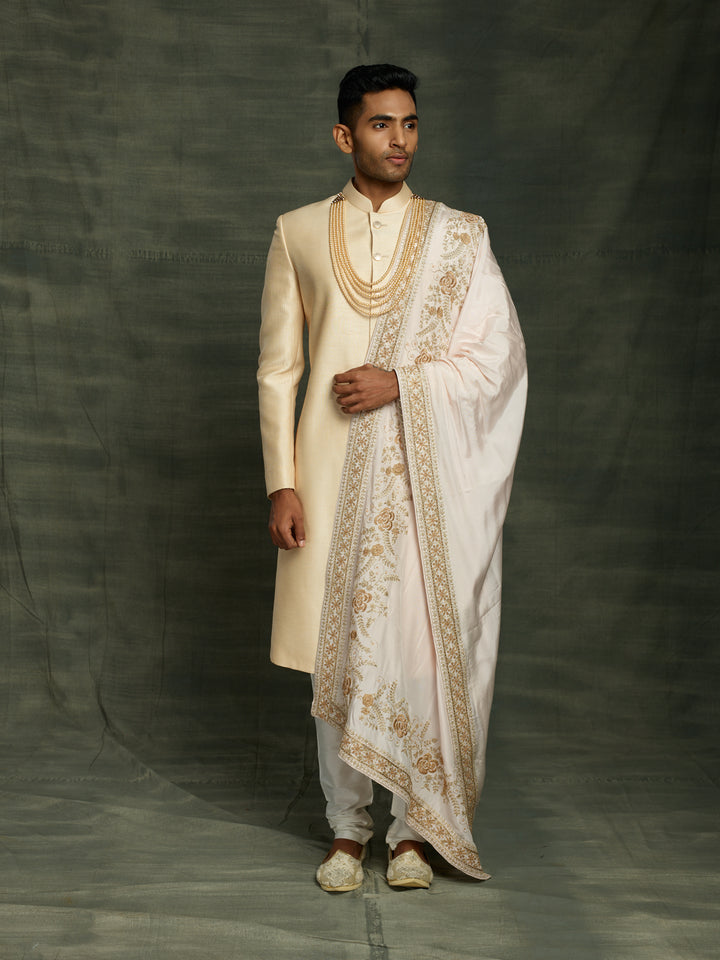 Gold sherwani with off-white dupatta.