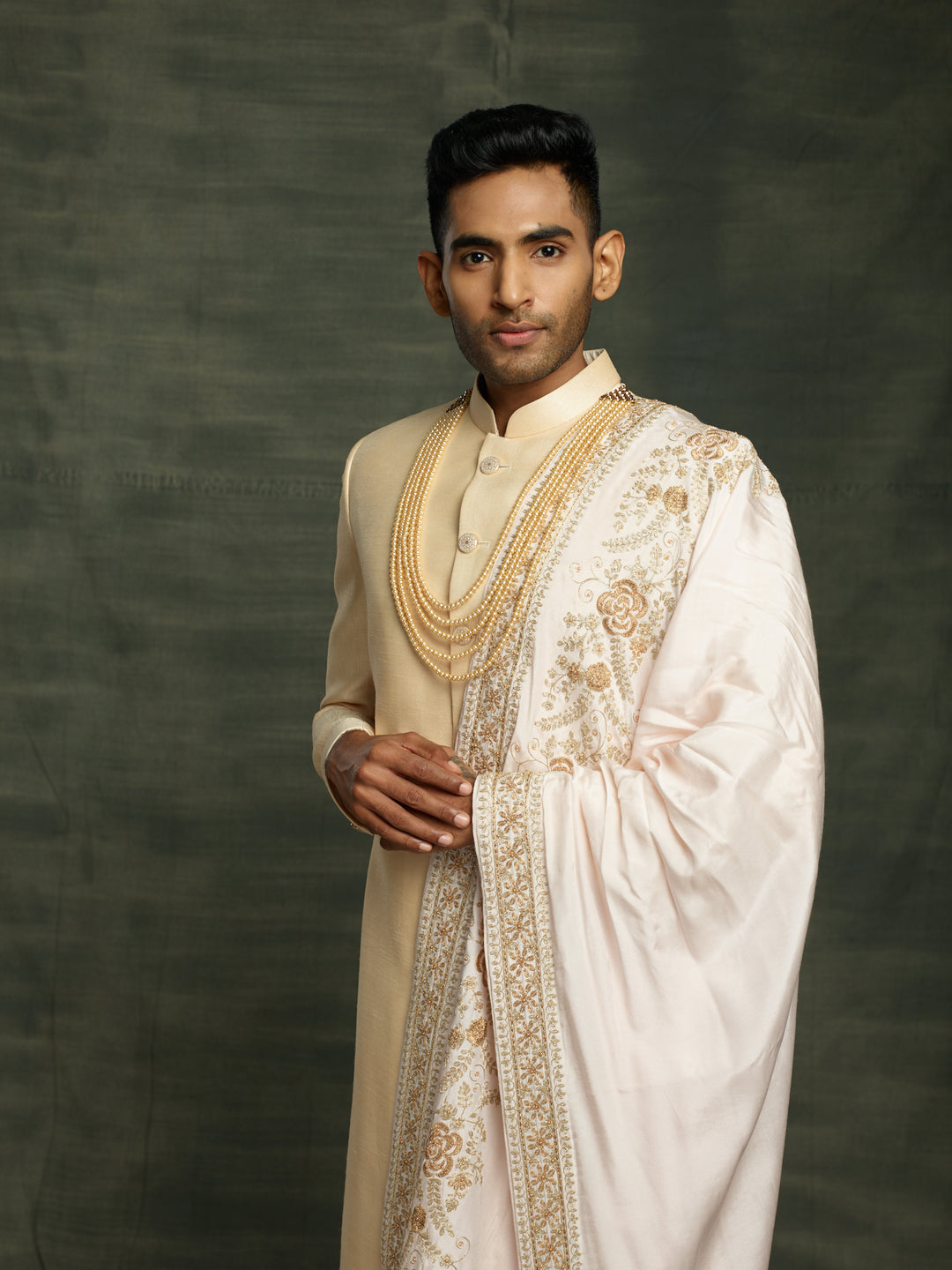 Gold sherwani with off-white dupatta.