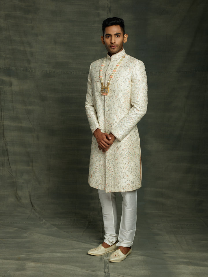 Off-white silk sherwani with peach highlights.