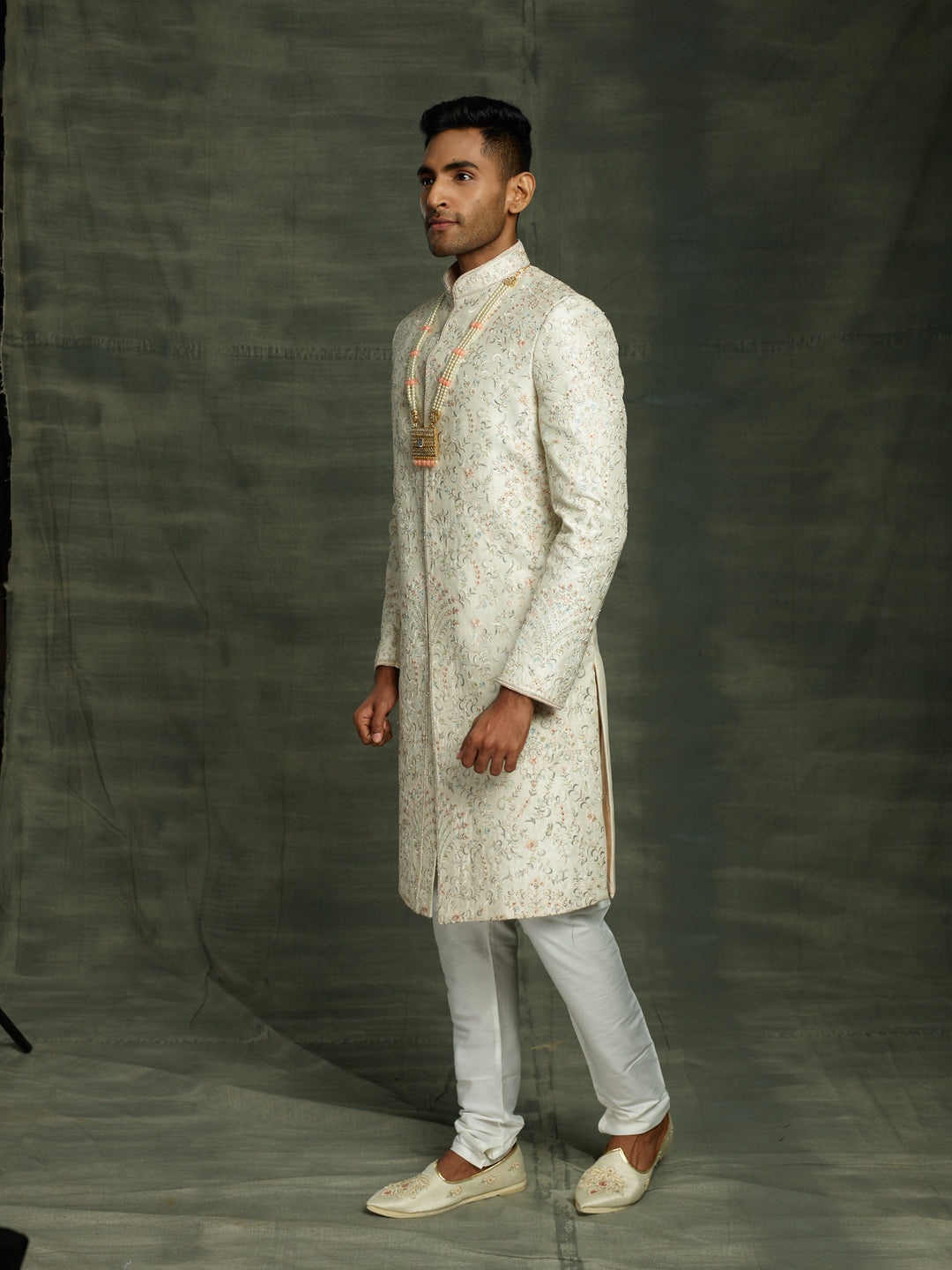 Off-white silk sherwani with peach highlights.