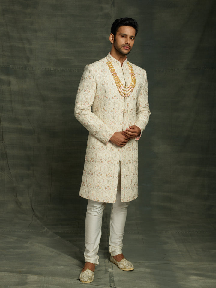 Groom's lakhnavi sherwani in ivory color.