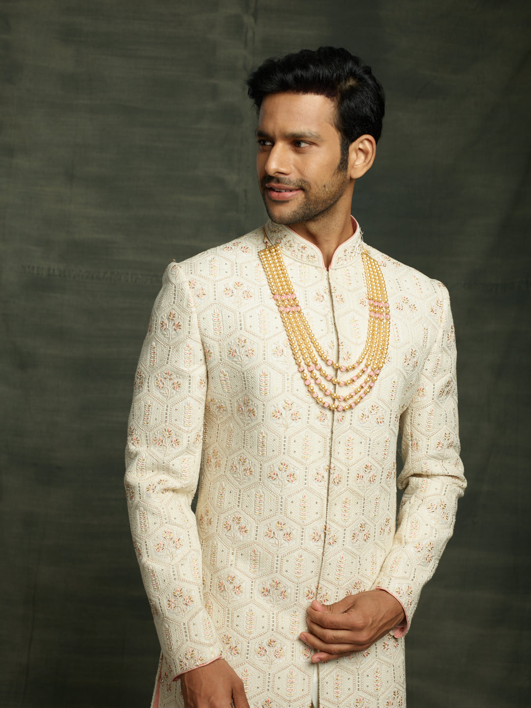 Groom's lakhnavi sherwani in ivory color.
