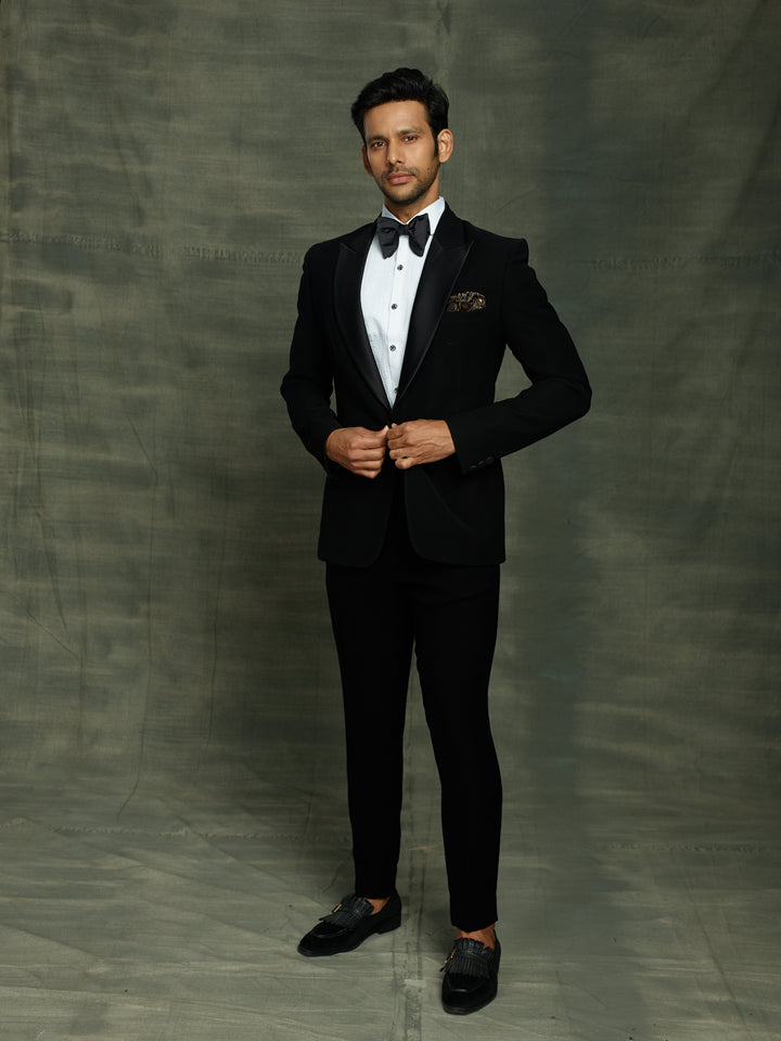 Classic black suit with waist belt.