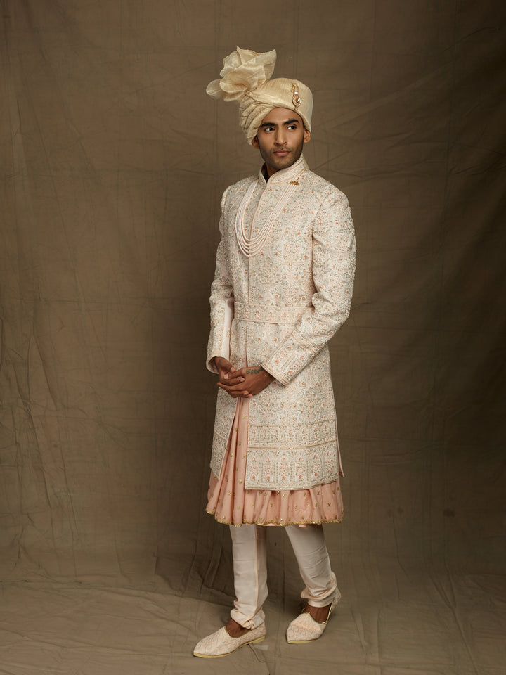Groom's wear sherwani in peach color.