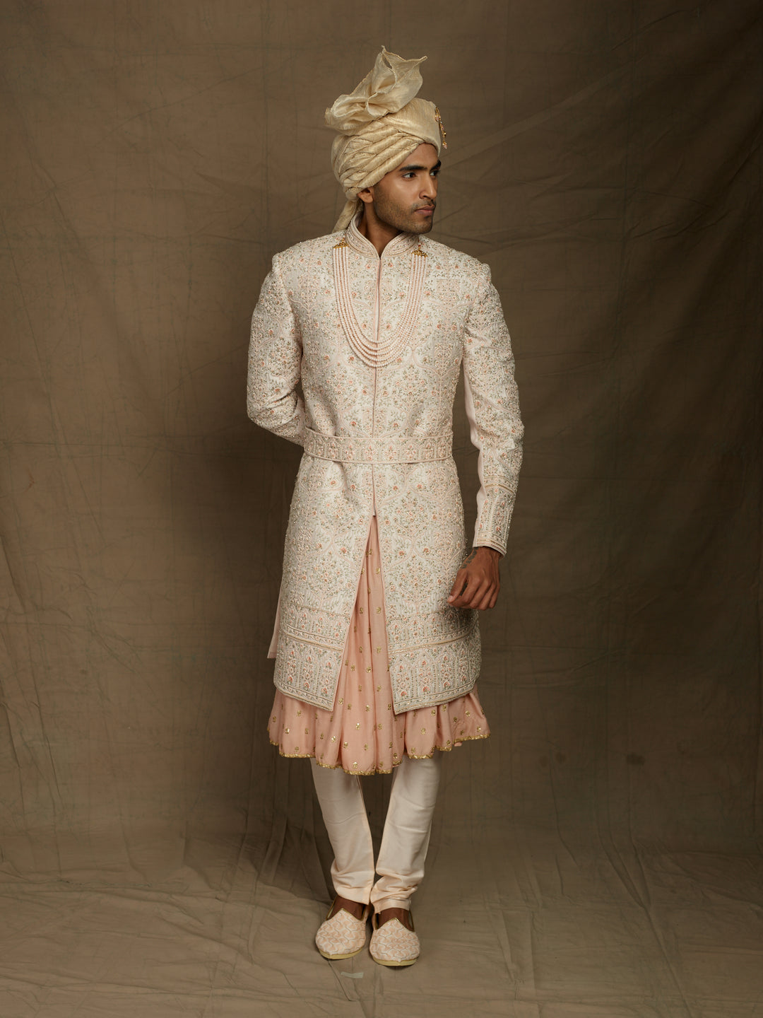 Groom's wear sherwani in peach color.