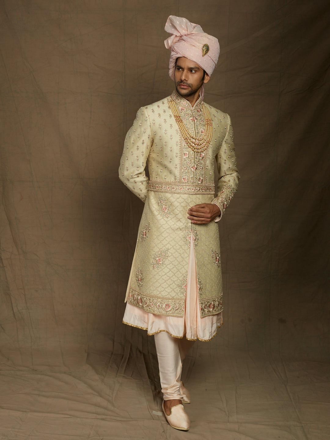 Cream sherwani with peacock feather motifs