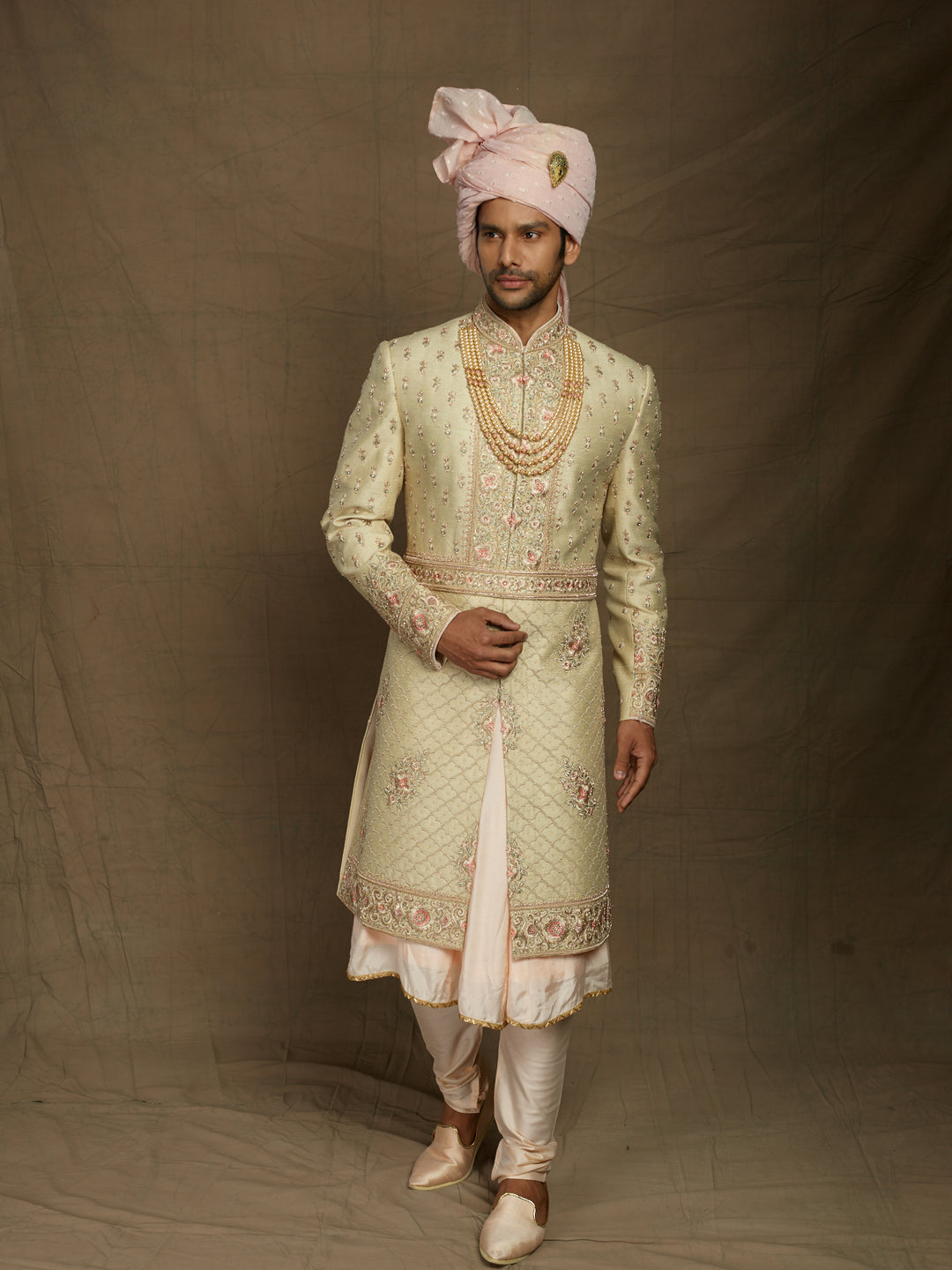 Cream sherwani with peacock feather motifs