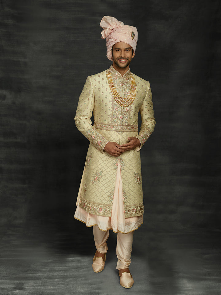 Cream sherwani with peacock feather motifs