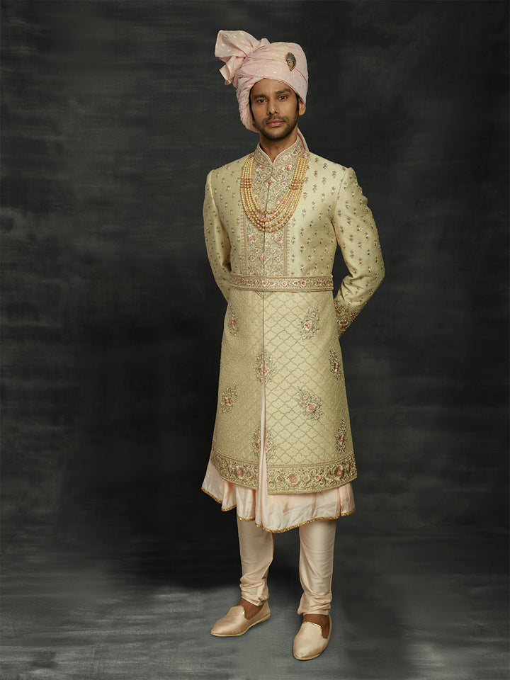 Cream sherwani with peacock feather motifs