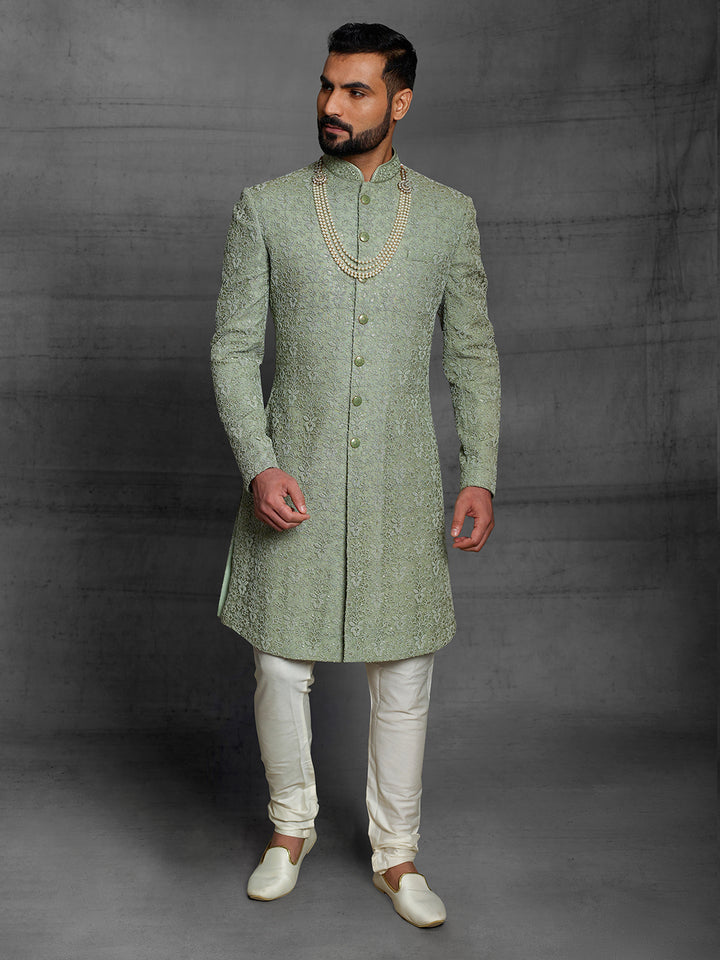 Simple net sherwani in green color.