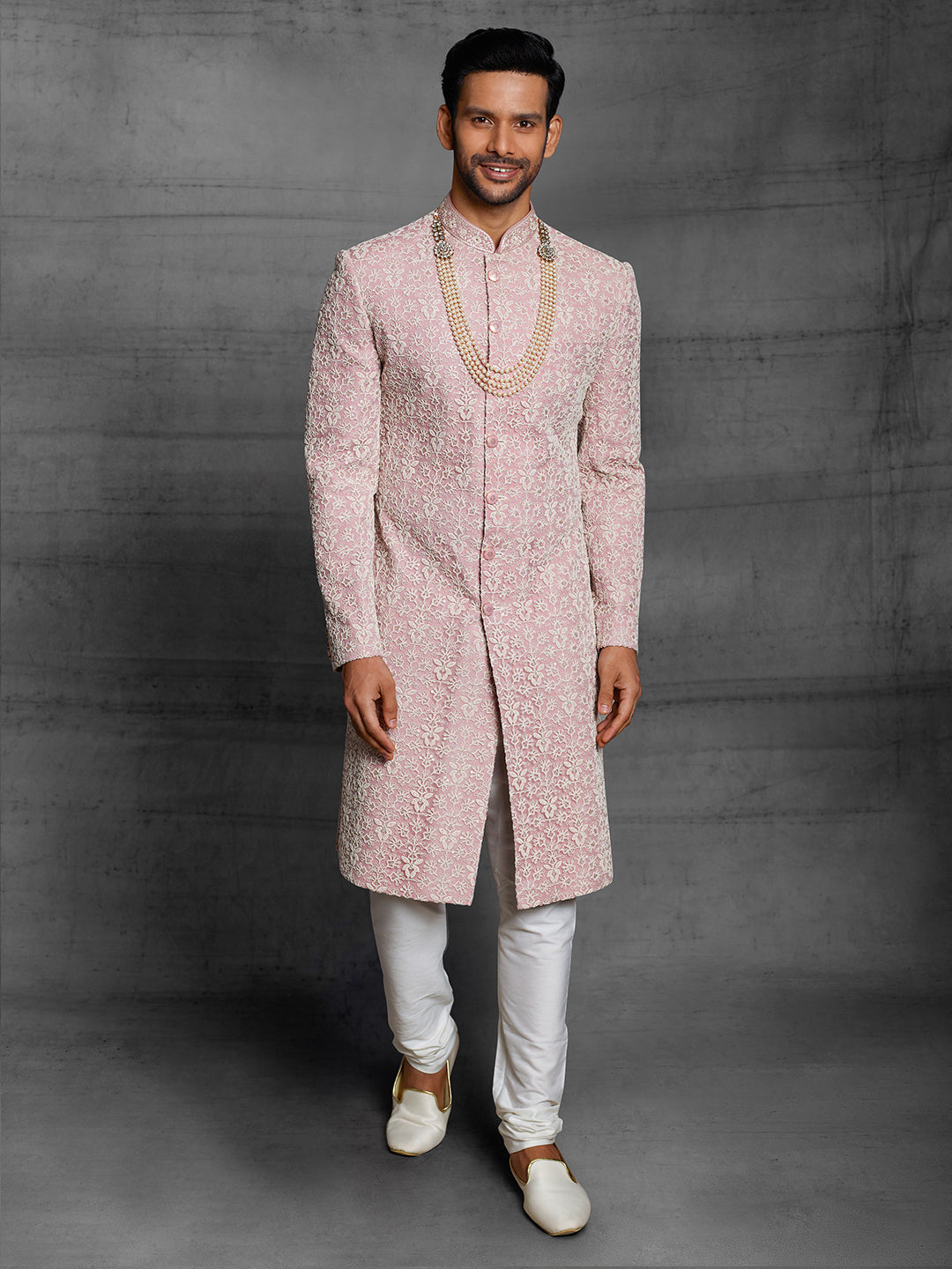 Simple net sherwani in onion pink color.