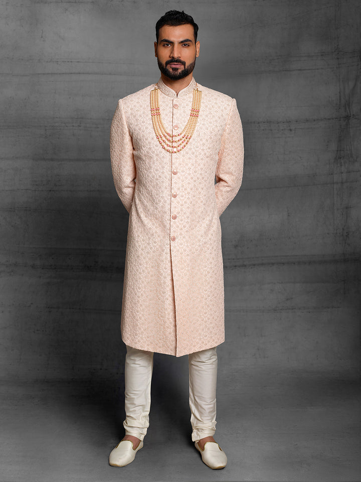 Net fabric based sherwani in peach color.