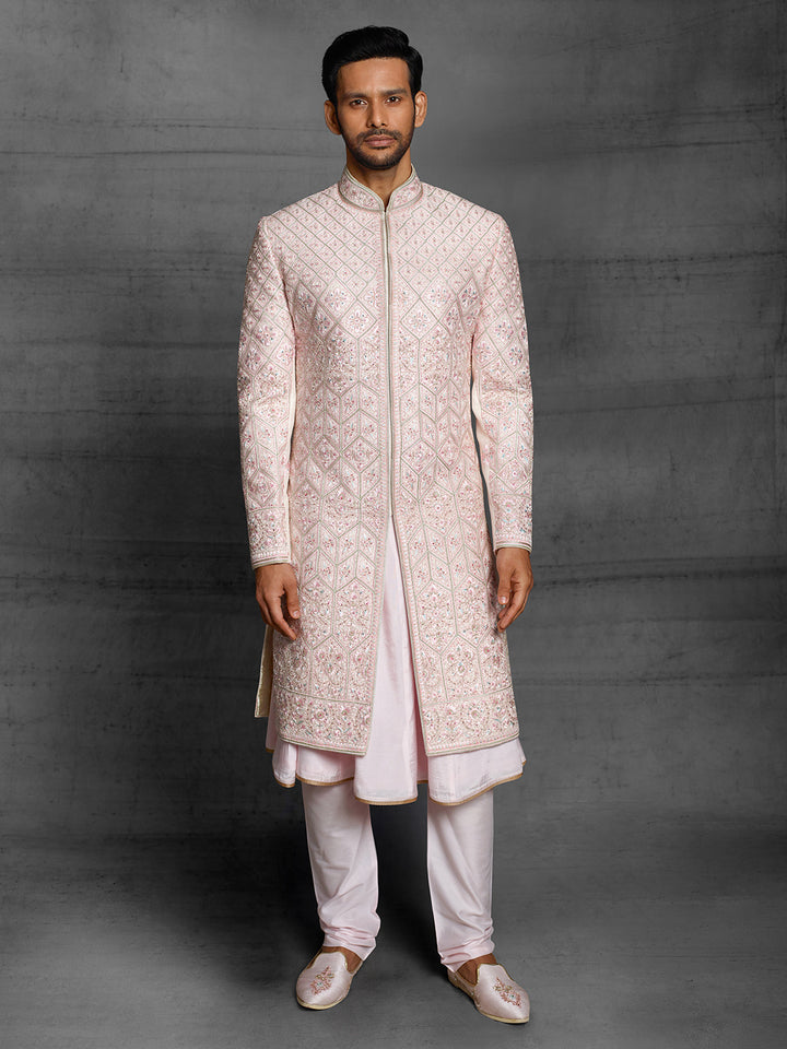 Powder pink sherwani with overall resham embroidery.
