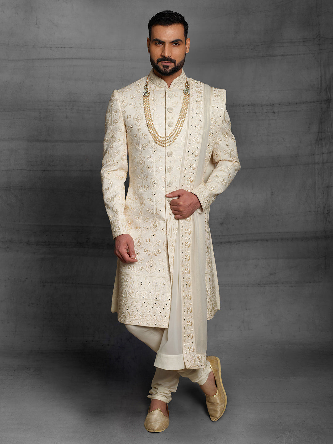 Cream sherwani with matching dupatta.