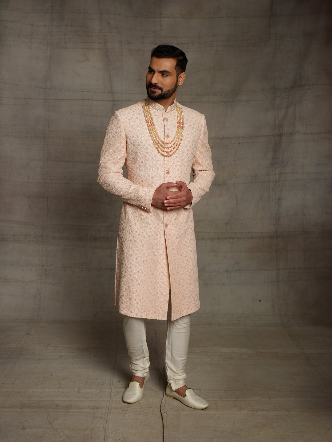 Net fabric based sherwani in peach color.