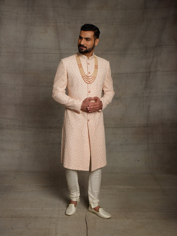 Net fabric based sherwani in peach color.