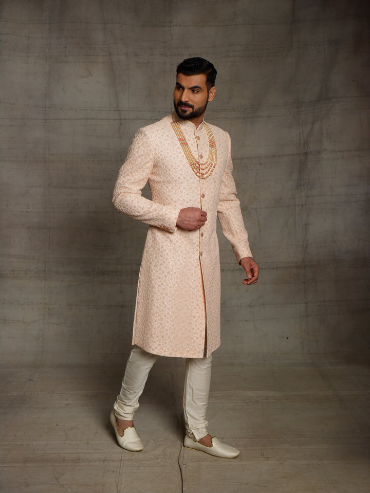 Net fabric based sherwani in peach color.