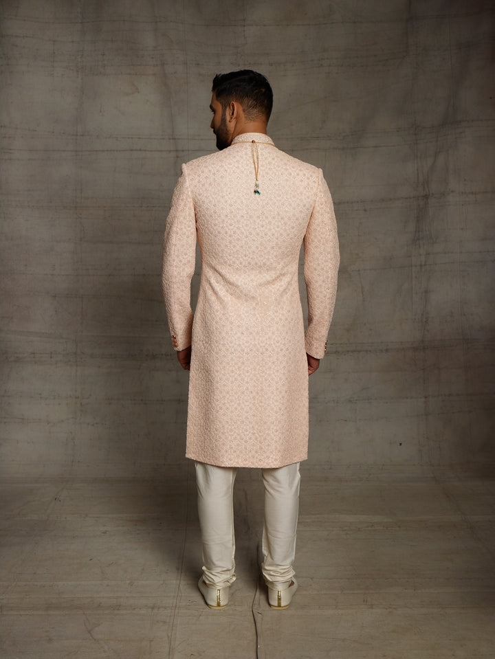 Net fabric based sherwani in peach color.