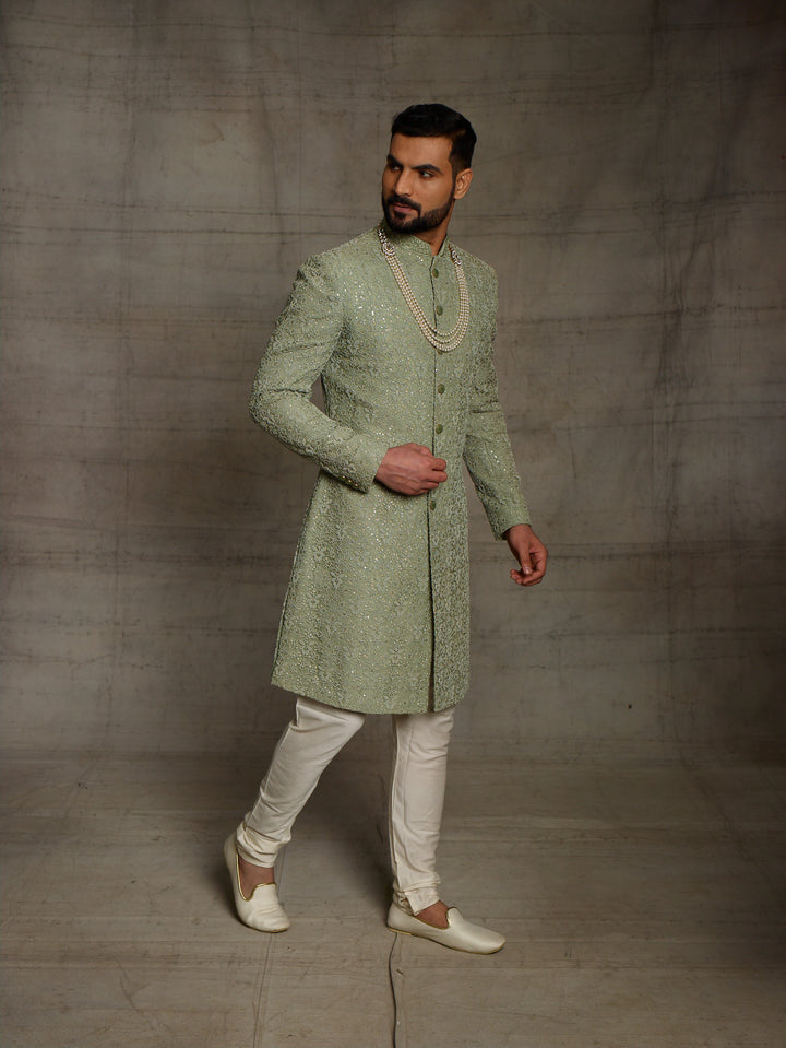 Simple net sherwani in green color.