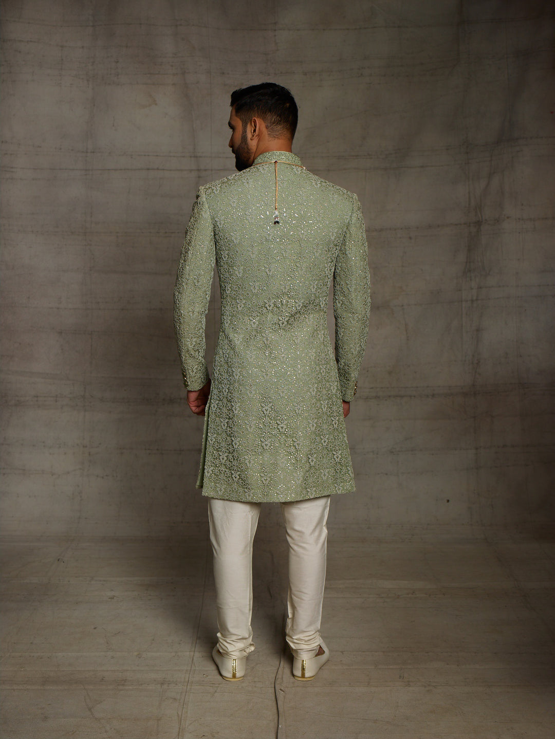 Simple net sherwani in green color.