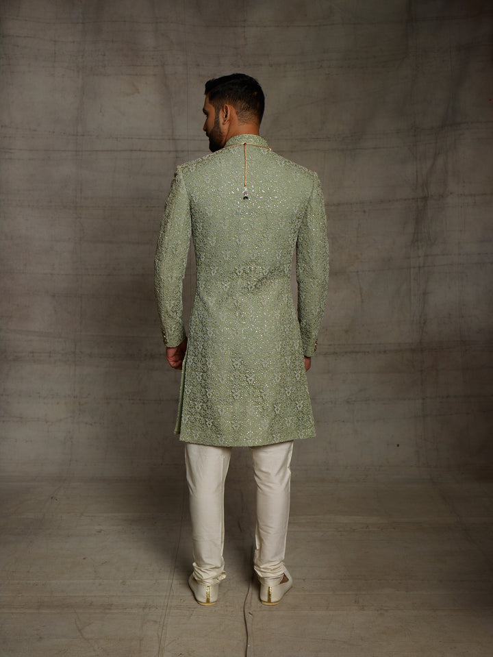 Simple net sherwani in green color.