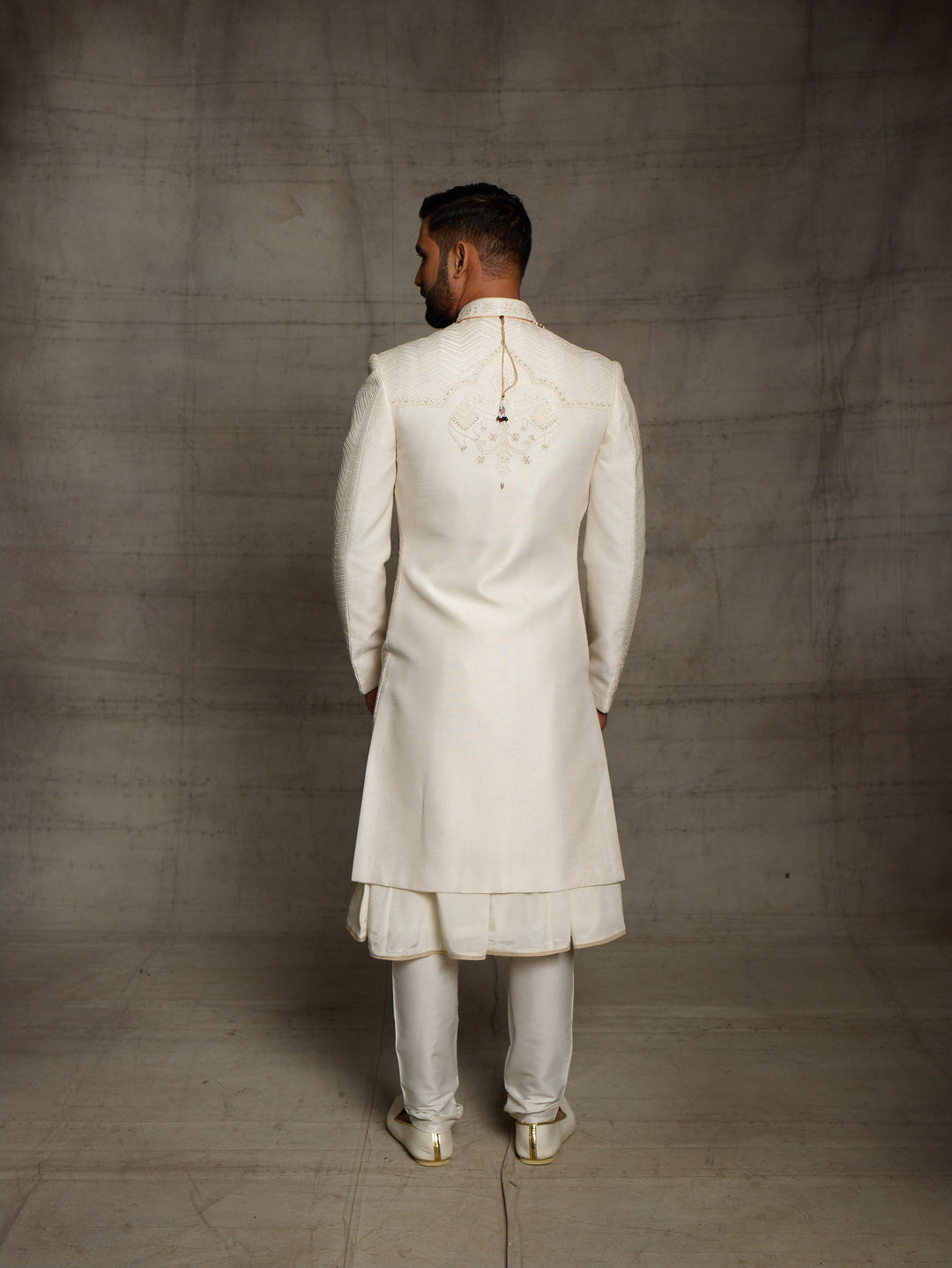 Off-white sherwani with elephant motif on daman