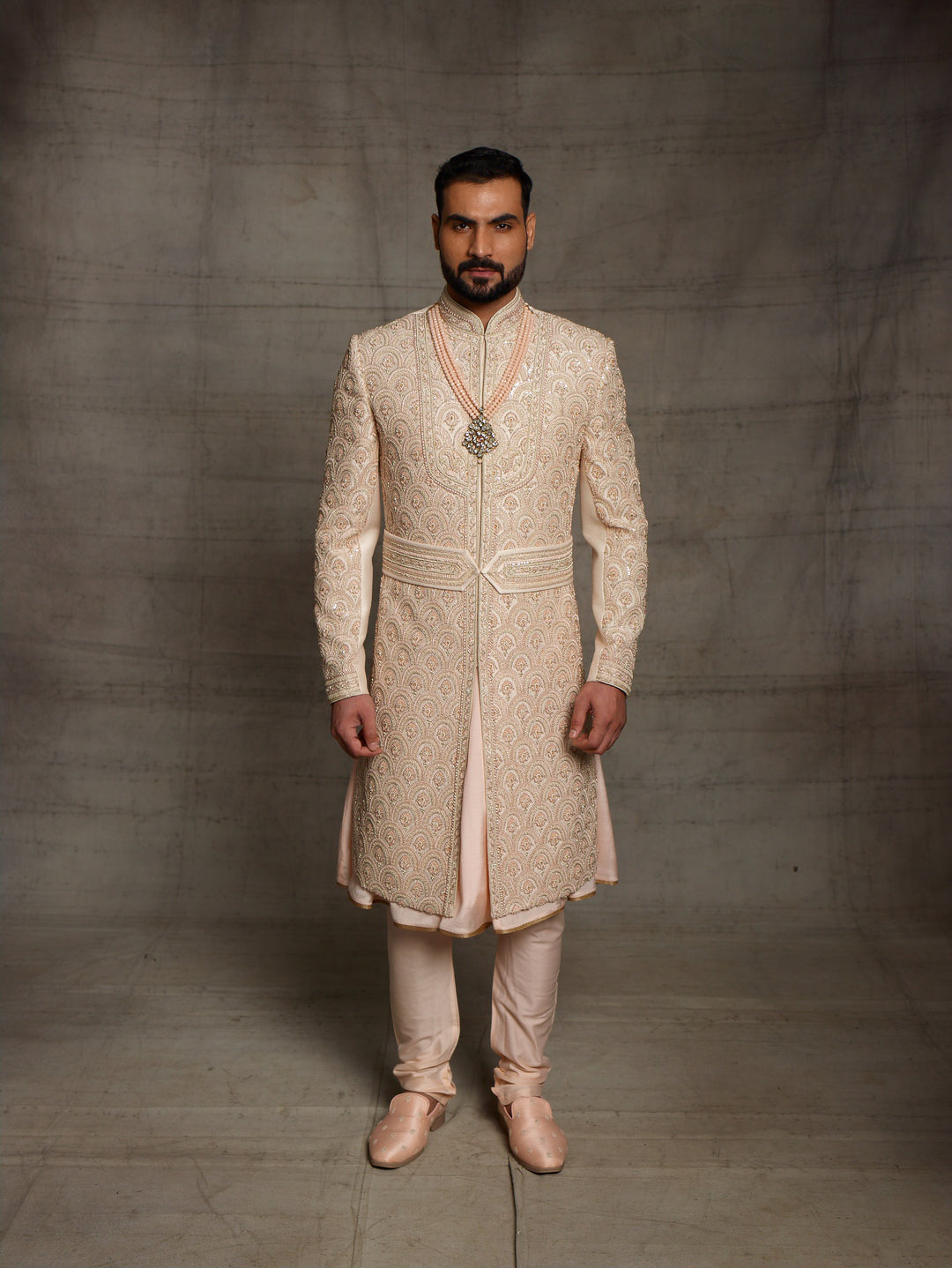 Overall embroidered sherwani in light gold color.