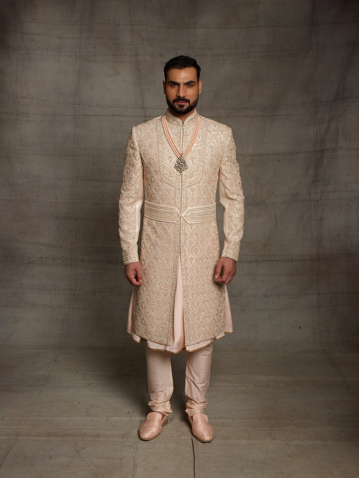 Overall embroidered sherwani in light gold color.