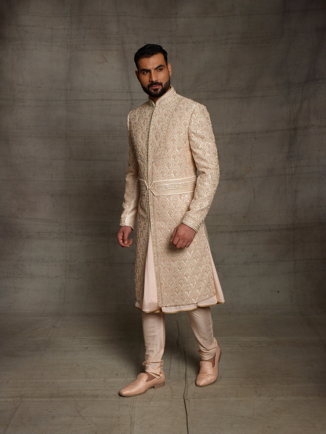 Overall embroidered sherwani in light gold color.