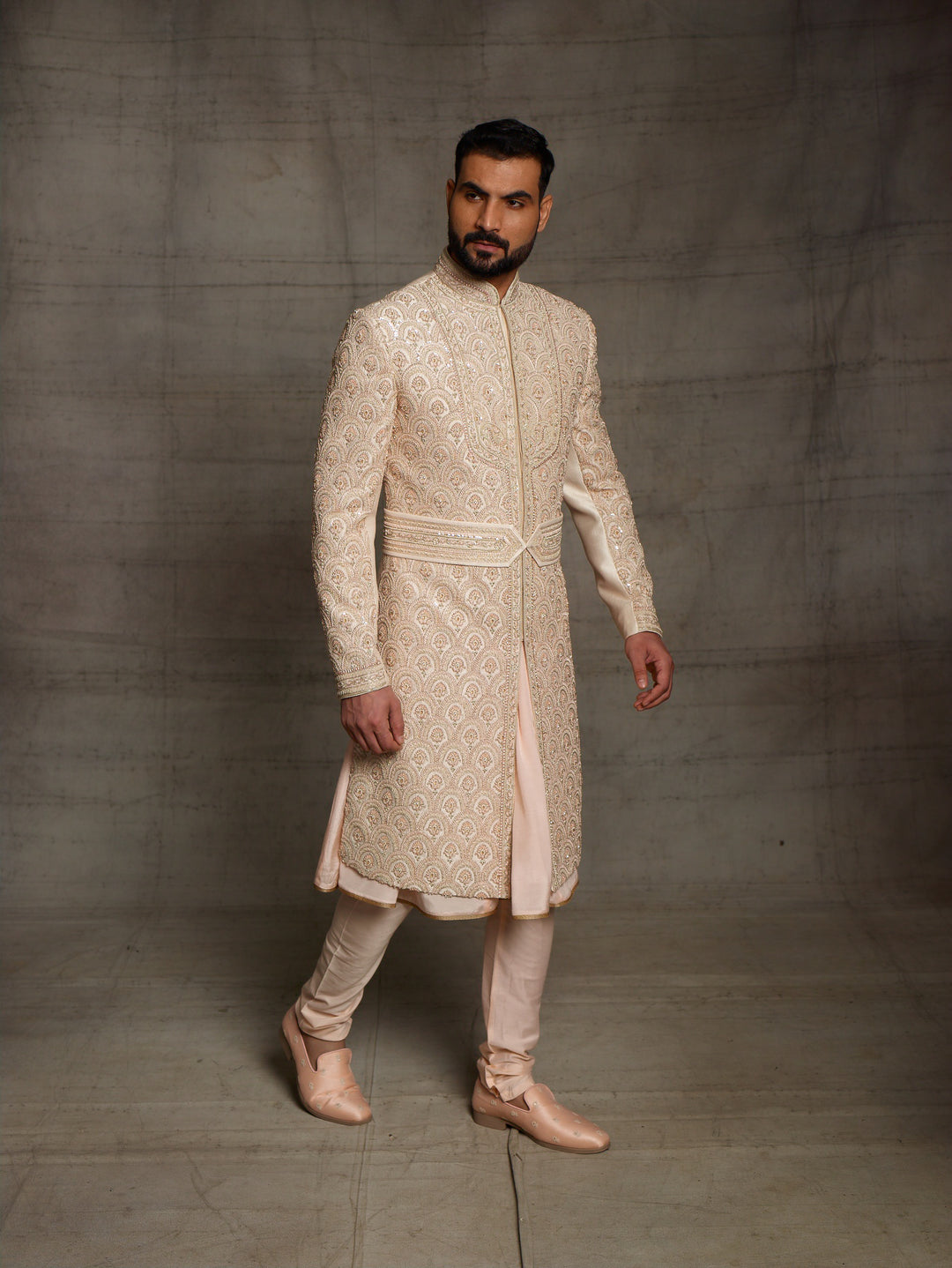 Overall embroidered sherwani in light gold color.