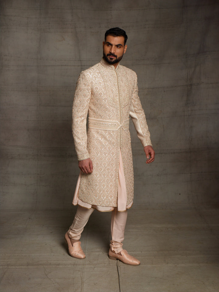 Overall embroidered sherwani in light gold color.