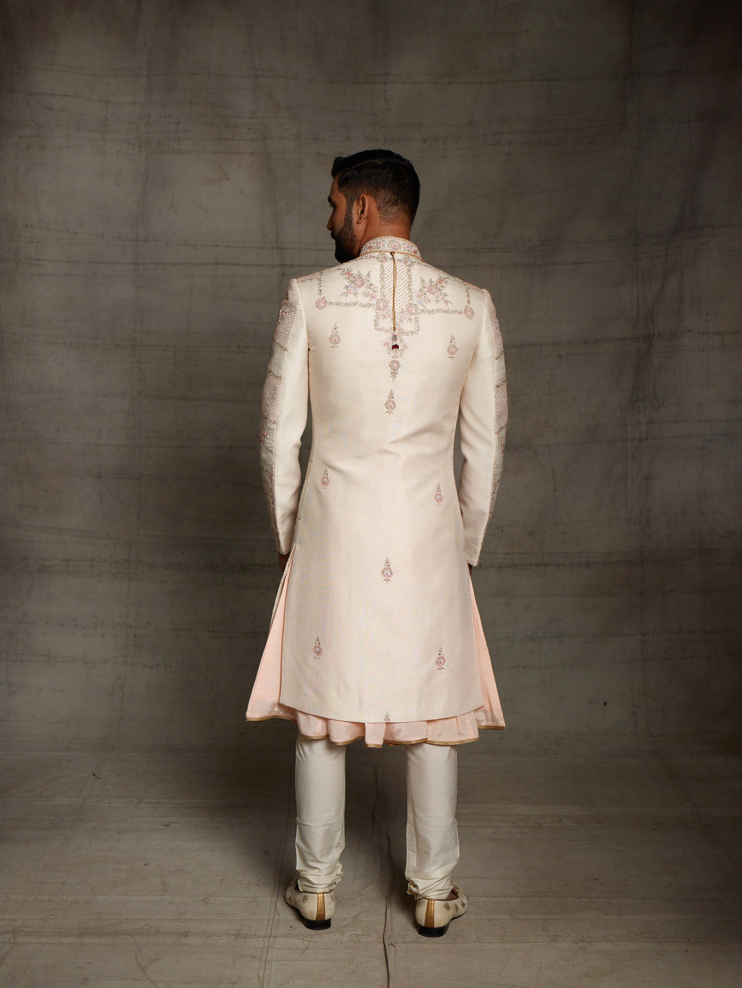 Light peach grooms wear sherwani with geometric design.