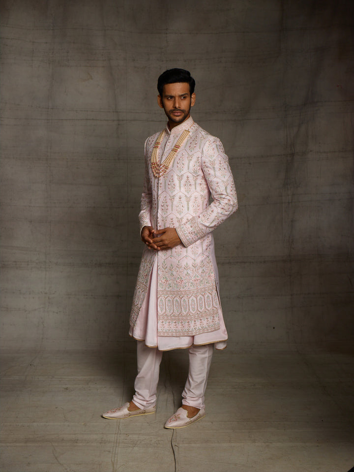 Designer groomwear sherwani in powder pink color.