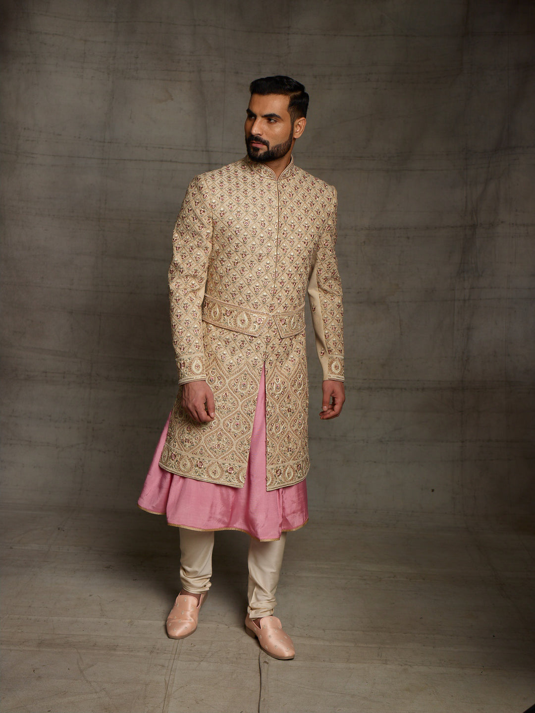 Gold sherwani with symmetric design and traditional kamarbandh